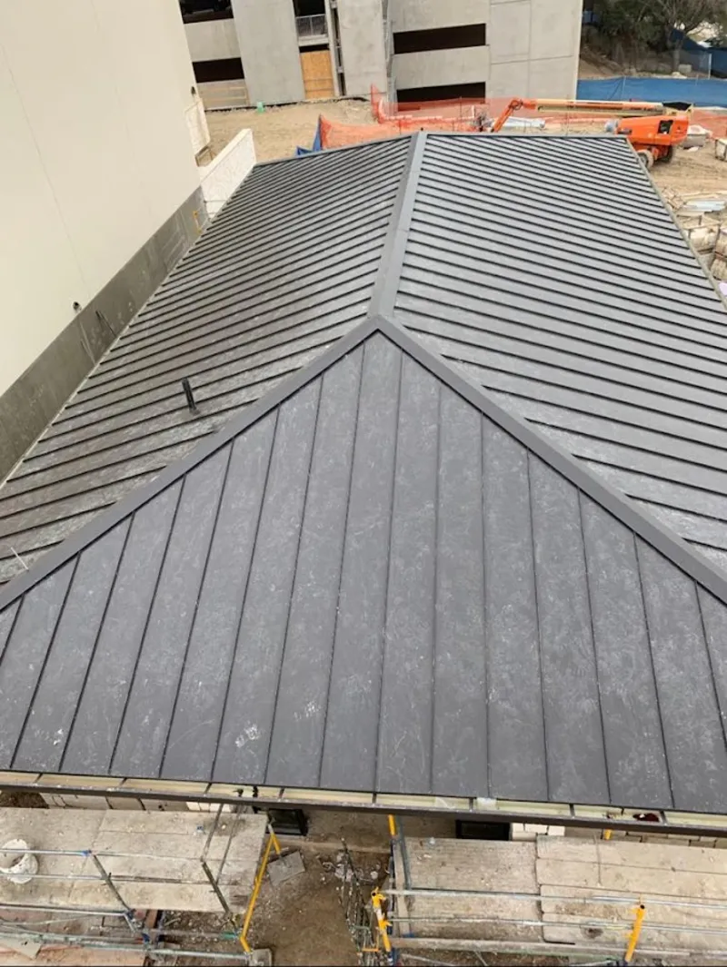 Commercial metal roof construction with crane equipment in Grove City